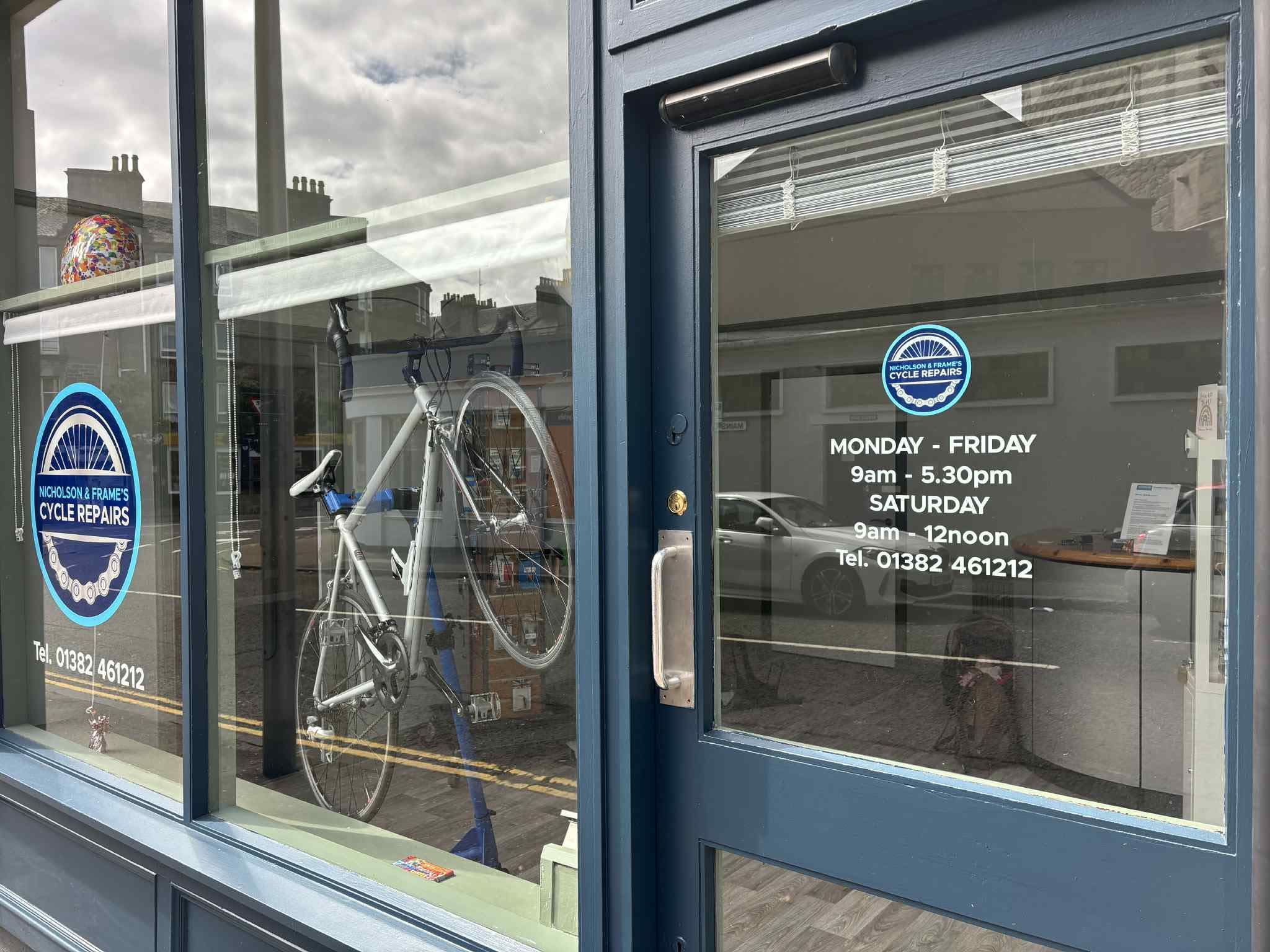 The entrance and blue shopfront at Nicholson & Frames, Mains Loan